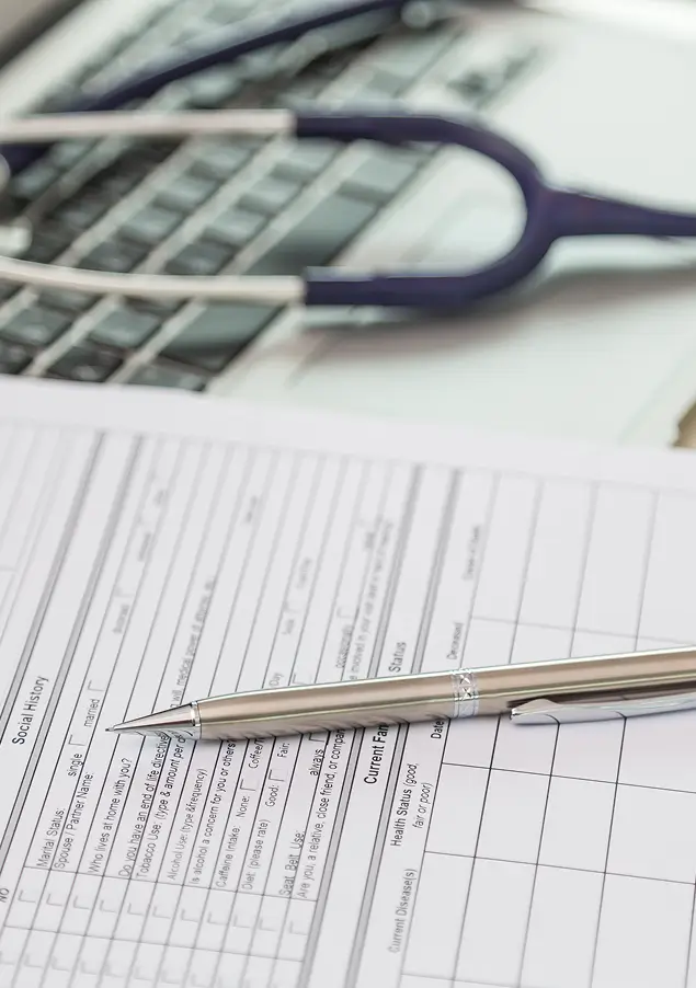 Close-up of a clipboard with a stethoscope in the background